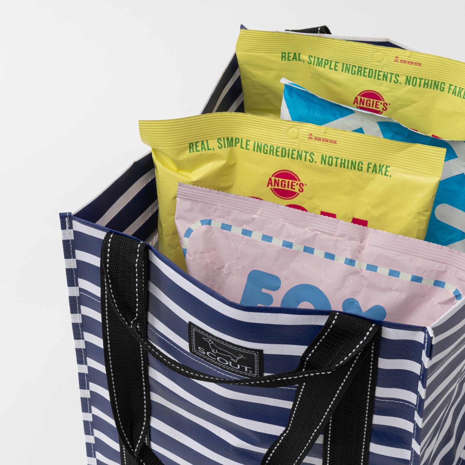 Striped tote bag with food packages inside