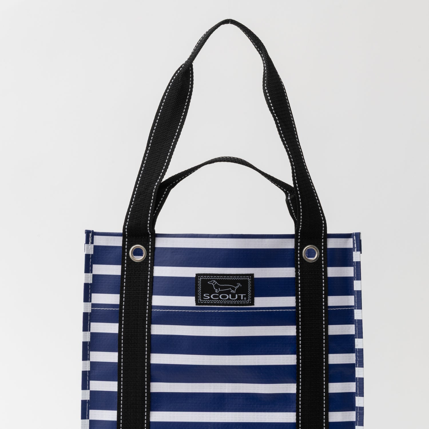 Blue and white striped tote bag with black handles on a light gray background