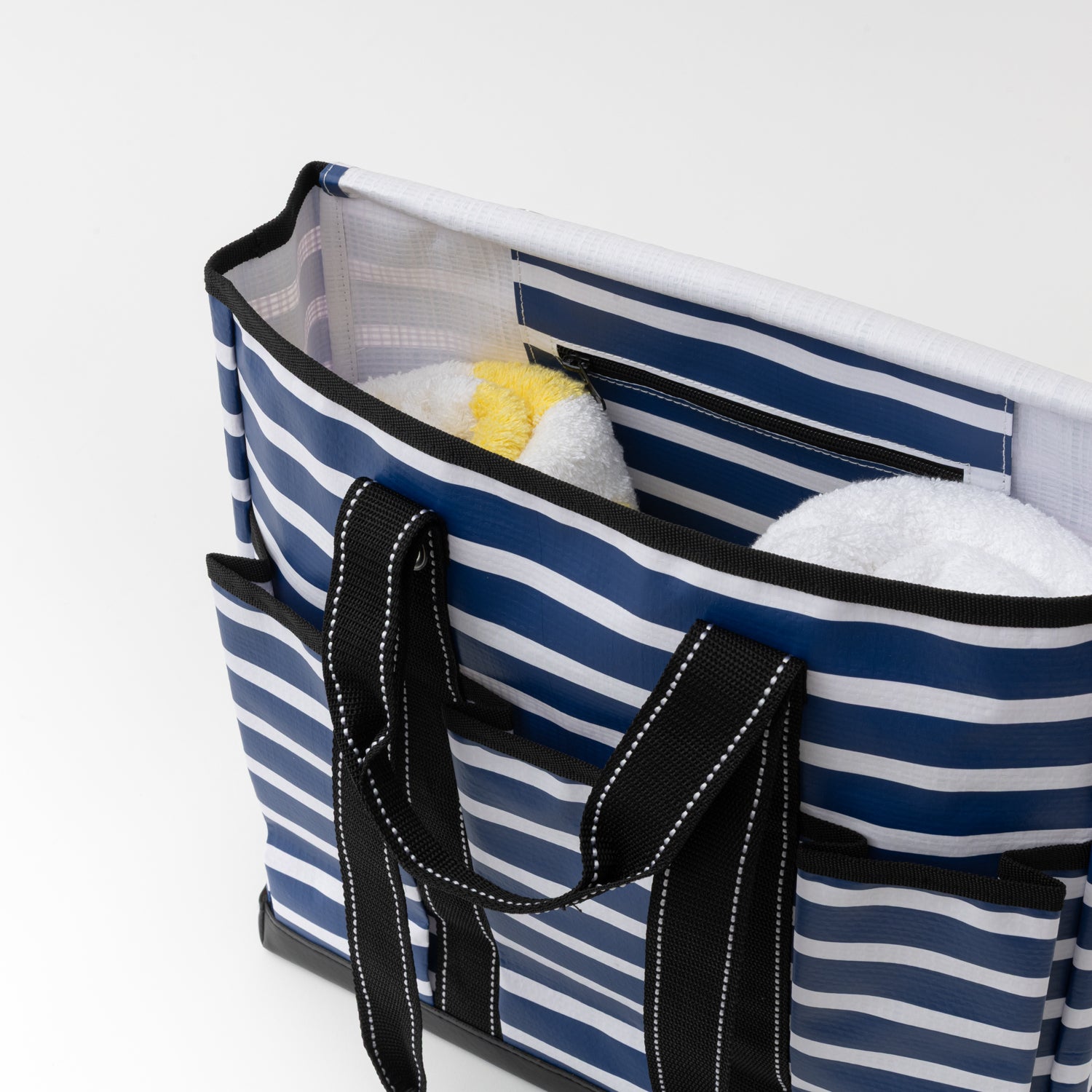 Blue and white striped tote bag with black handles on a white background