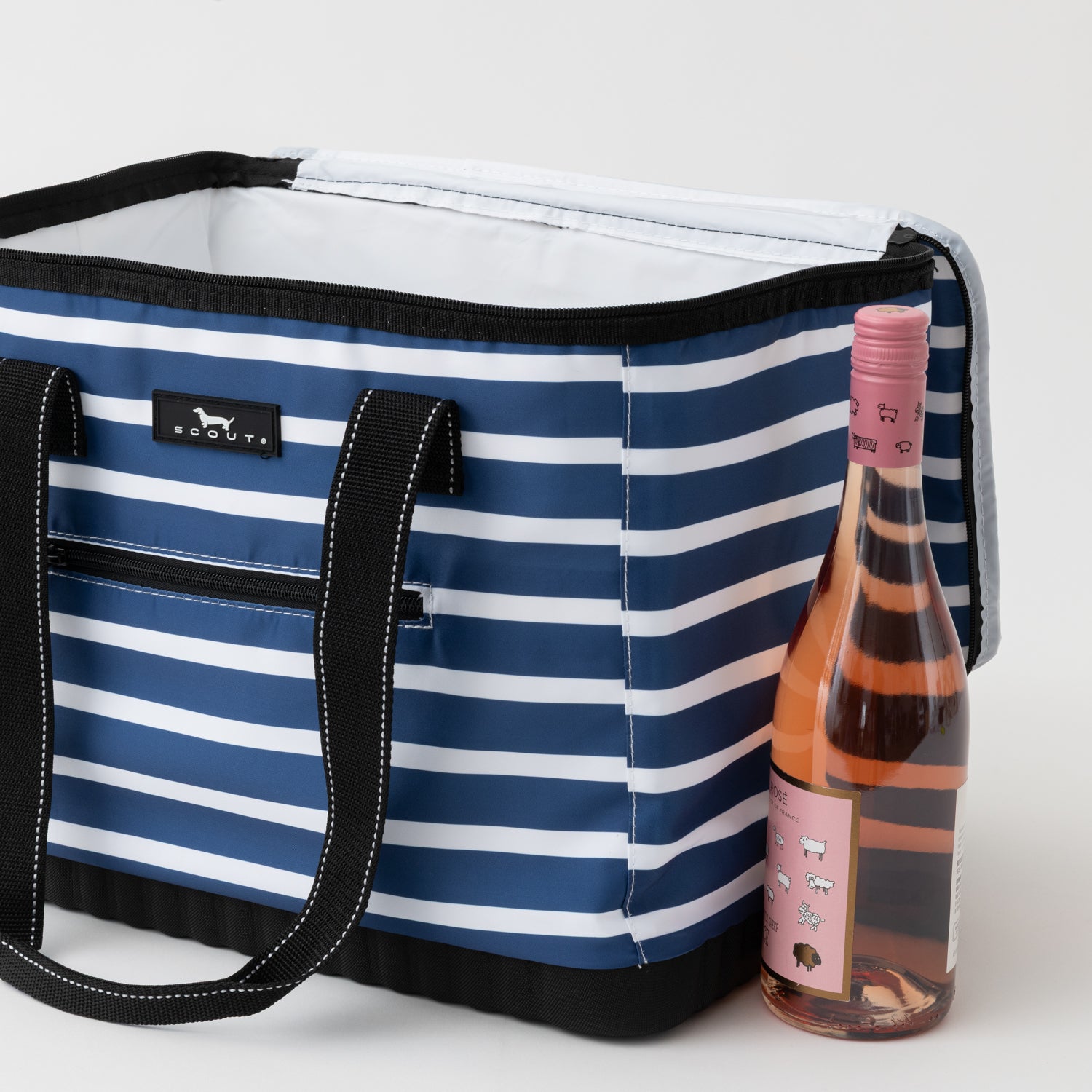 Blue and white striped cooler bag with a bottle of pink wine on a light gray background