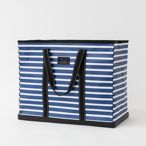 Blue and white striped tote bag with black handles on a light gray background