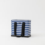 Blue and white striped tote bag with black handles on a light gray background