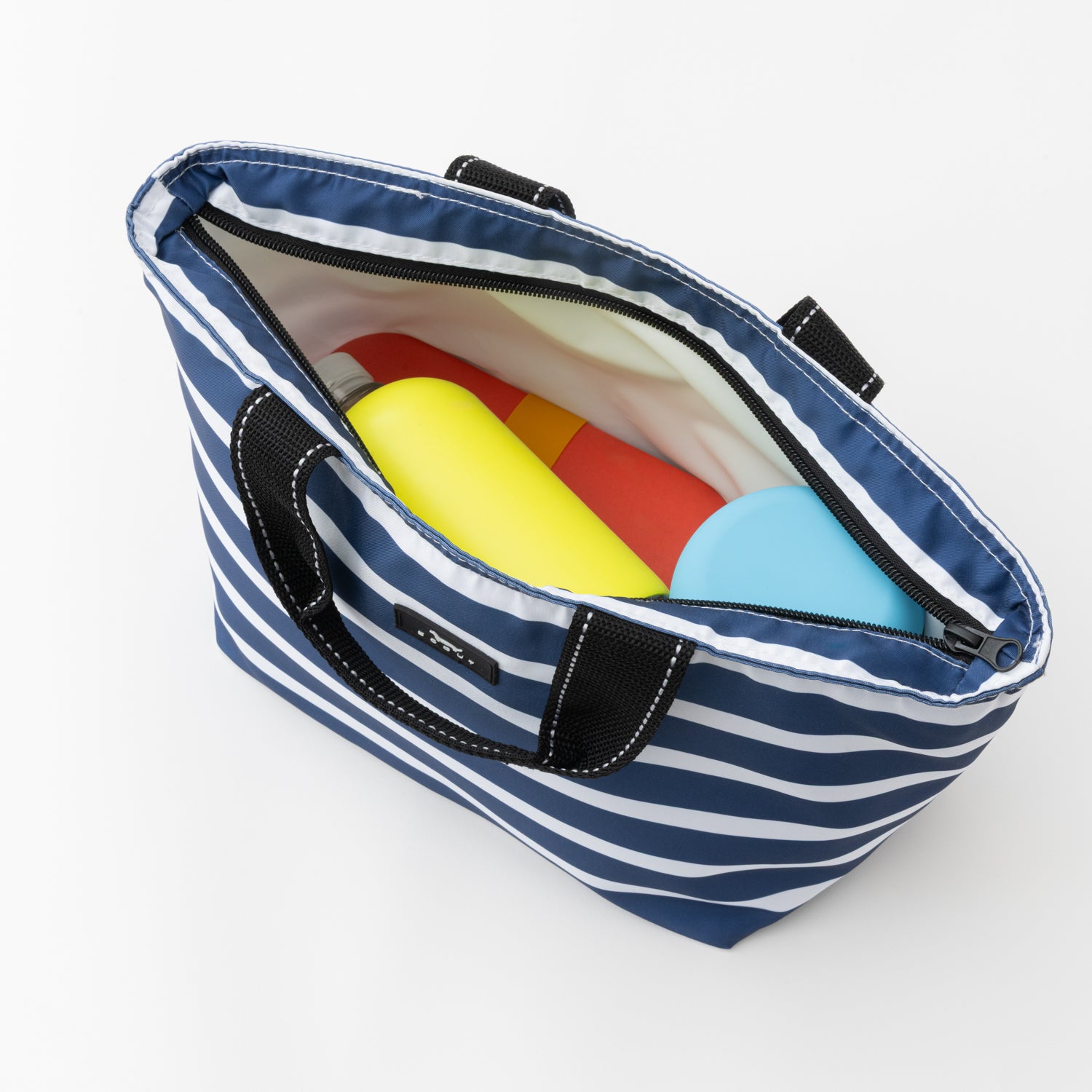 Blue and white striped bag with lunch items on a white background