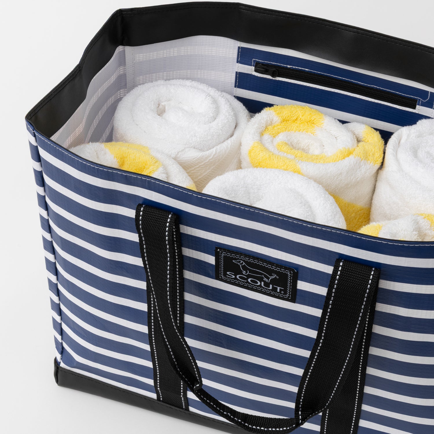 Blue and white striped tote bag with towels inside, featuring a Scout logo.