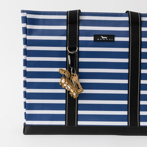 Blue and white striped bag with a gold keychain on a white background