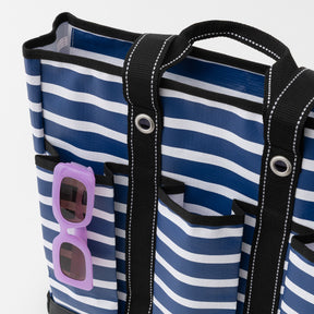 Blue and white striped bag with sunglasses pocket on a white background